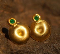 This lovely pair of gold and green emerald earrings Made of 2 mm green emerald (AAA quality) which have been set into a solid 22k yellow gold setting with a beautiful matte finish (can also be polished to a high luster finish) post is made with 20k gold. ear nut is 14k gold This is a one of a kind item These studs are wonderful as a gift, for someone you love, or for yourself. They are suitable for every occasion, for the day, or for the evening. Last forever and only gets more beautiful with ti Formal Green 22k Gold Earrings, Gold Emerald Temple Jewelry Earrings, Green Emerald Earrings, Emerald Studs, 22k Gold Earrings, Emerald Green Earrings, Emerald Earrings Studs, Gold Nugget, Tiny Earrings