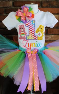 PLEASE REFER TO OUR ANNOUNCEMENT PAGE FOR CURRENT TURNAROUND TIME PRIOR TO PLACING YOUR ORDER This is the perfect birthday outfit for your Little Care Bear! -Available for ages 1 to 9 years ( please specify child's age in notes at checkout) -Great for pictures this bodysuit/shirt is embroidered with beautiful high quality colored thread along with high quality vinyl , regular solid & glitter fabric guaranteed not to shed(no mess) -The Beautiful soft full Tutu is handmade on a crochet head ba Care Bears 1st Birthday Outfit, Care Bear First Birthday Outfit, Care Bear 1st Birthday Outfit, Care Bear Birthday Shirts, Care Bears Theme Party, Carebears Birthday Theme, Care Bear 1st Birthday Party Ideas, Care Bear First Birthday Party, Care Bears Centerpieces