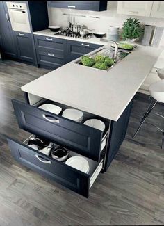 an open drawer in the middle of a kitchen island