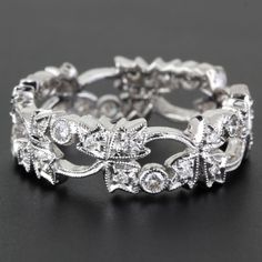 an intricately designed wedding band with diamonds