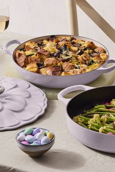 two pans filled with food sitting on top of a table next to each other