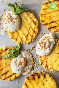 grilled pineapples topped with whipped cream and mint