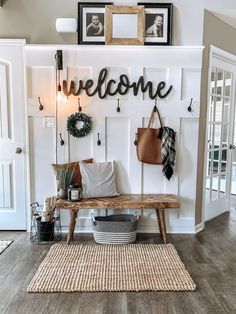 a welcome sign hanging on the wall above a bench