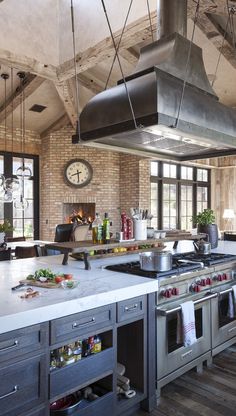 a kitchen with an oven, stove and counter top in the middle of it's center island