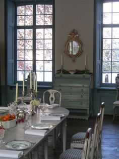 the dining room table is set with place settings