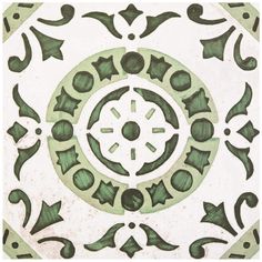 a green and white tile with an intricate design