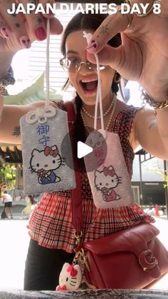 a woman holding up two hello kitty bags in front of her face with the caption japandaries day 8