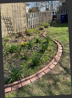 a brick garden edging in front of a house