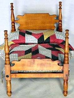 a wooden bed with a quilt on it