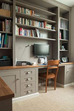 a home office with bookshelves, desk and chair