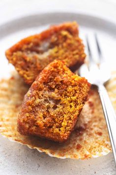 two pieces of cake on a plate with a fork