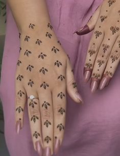 a woman's hands with tattoos on them