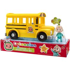 a yellow toy bus with two dolls in the front and one on the back side