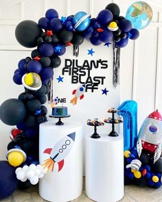 a space themed birthday party with balloons, rockets and stars on the front door frame