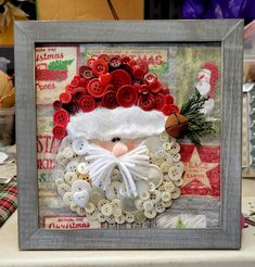 a christmas card with buttons and a santa clause hat on it, surrounded by other holiday items