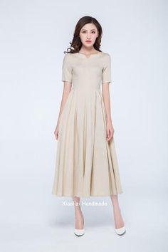 cream dress Classic V-neck Midi Dress For Summer, Elegant Pleated V-neck Dress With Short Sleeves, Summer Pleated V-neck Dress With Short Sleeves, Beige A-line Linen Dress For Spring, Spring Beige A-line Linen Dress, Spring Solid Color Midi Dress With Notched Neckline, Spring Midi Dress With Notched Neckline, Cream A-line Linen Dress, Chic Short Sleeve Tea Length Dress