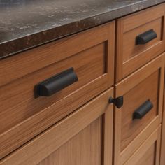 an image of a kitchen counter top that is made out of wood and has black handles