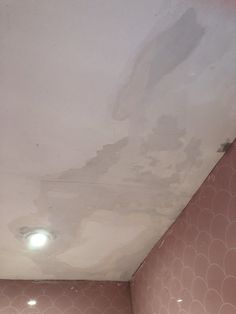 a bathroom that has some kind of mold on the ceiling