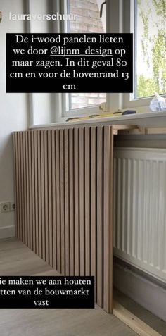 a wooden paneled window sill next to a radiator in a room