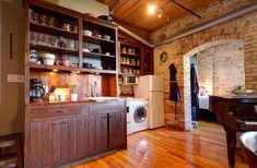 a kitchen with wooden floors and cabinets in it