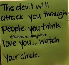 a hand holding a sign that says the devil will attack you through people you think love you watch your circle