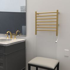 a bathroom with two sinks and a yellow towel rack on the wall next to it