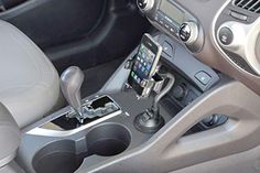 the inside of a car with a cell phone holder in it's center console