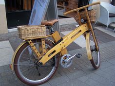 a yellow bicycle parked on the side of a street