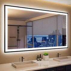 a bathroom with two sinks and a large mirror over the sink that is lit up