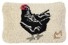 an embroidered pillow with a chicken on it