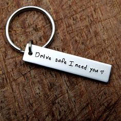 a metal keychain that says drive safe i need you? on the front