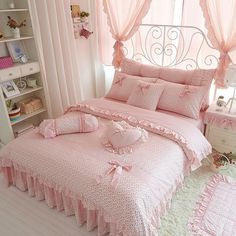 a bedroom with pink bedding and curtains