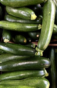 many cucumbers are stacked up on top of each other