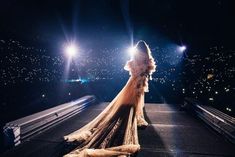 a woman standing on top of a roof at night