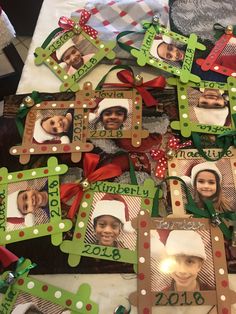 a table topped with lots of frames covered in christmas decorations and pictures on it's sides