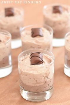 small desserts in glass cups with chocolate on top