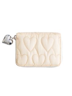 a white purse with hearts on it and a keychain hanging from the front