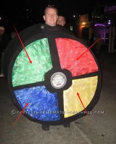 a man holding a giant wheel of fortune costume