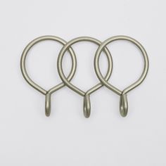 three metal rings on a white surface with one looped in to the other end