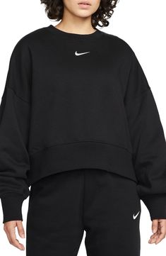 An embroidered Swoosh adds minimal branding to this cozy fleece sweatshirt cut for a relaxed, oversized fit that's enhanced by the dropped shoulders. 22" length (size Medium) Crewneck 80% cotton, 20% polyester Machine wash, tumble dry Imported Nike Phoenix Fleece, Black Nike Sweatshirt, Nike Crew Neck, Nike Sportswear Women, Nike Crewneck, Women's Sportswear, Nike Fleece, Oversized Crewneck, Cut Sweatshirts