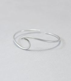 Wave cuff bangle, sterling silver, beach jewellery, ocean, beach bracelet, minimalist, adjustable, gift for her, one size Sterling silver solid cuff hand formed to a wave shape from 12 gauge (2 mm) wire. Comfortable to wear all day or sleep with and sturdy. This bangle is slightly adjustable and thus one size. It will fit most wrists (14 -18 cm / 5.5 - 7 inches wrist). But you can always ask for a different size. The bracelet above is not the exact one you will receive. Each one is handmade to o Beach Minimalist, Ocean Bracelet, Beach Jewellery, Beach Bracelet, Beach Bracelets, Bracelet Minimalist, Cuff Bangles, Beach Jewelry, Jewelry Inspiration