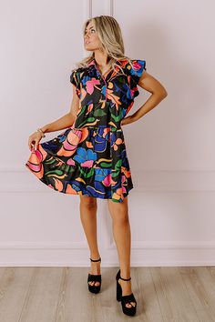 Chic Black Dress With Abstract Print, Black Dress With Abstract Print For Vacation, Black Abstract Print Dress For Vacation, Black Dress With Colorful Pattern, Spring Black Dress With Bold Print, Spring Black Dresses With Bold Print, Black Dresses With Bold Print For Spring, Black Dress With Vibrant Print For Vacation, Black V-neck Dress With Vibrant Print