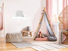 a child's bedroom with pink and white decor, including a teepee tent