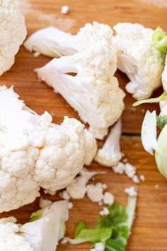 cauliflower florets and lettuce on a cutting board