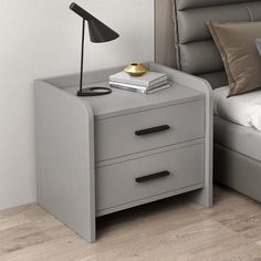 a night stand with two drawers and a lamp on the end table next to it