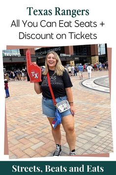 a woman holding a red heart shaped sign with the words texas rangers all you can eat seats and discount on tickets