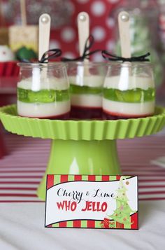 three desserts are on a green plate with red and white striped table cloth in the background