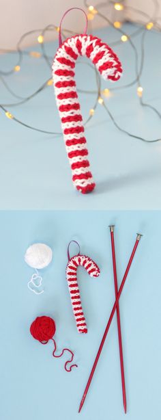 a candy cane and knitting needles on a blue surface