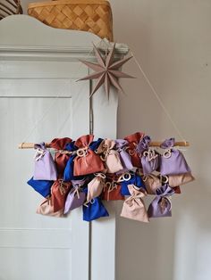 a star hanging from the ceiling next to some bags on a string with ribbons attached