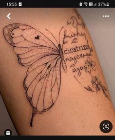 a butterfly tattoo on the arm with words written in cursive writing and flowers